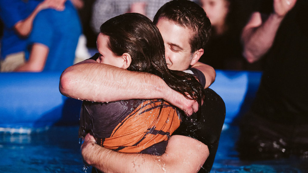 a couple hugging after a baptism